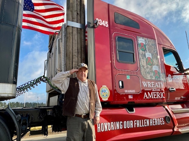 Driver Saluting the American Flag next to his truck